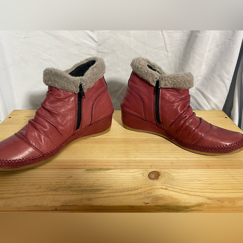 Red Anesha boots. Never worn.   Has a wedge heel. Is a size 39.